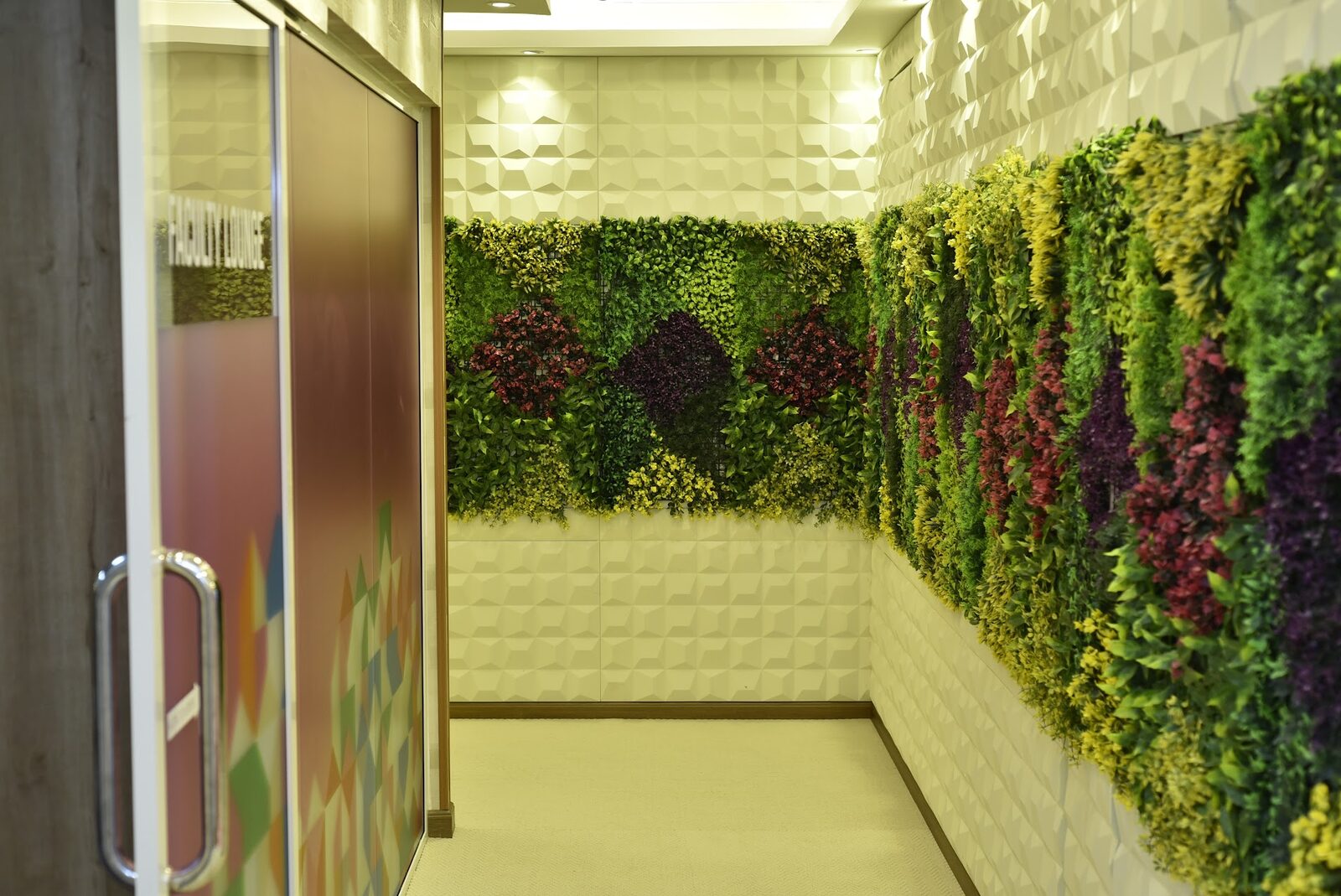 Corridor leading into the Faculty Lounge with a living green wall