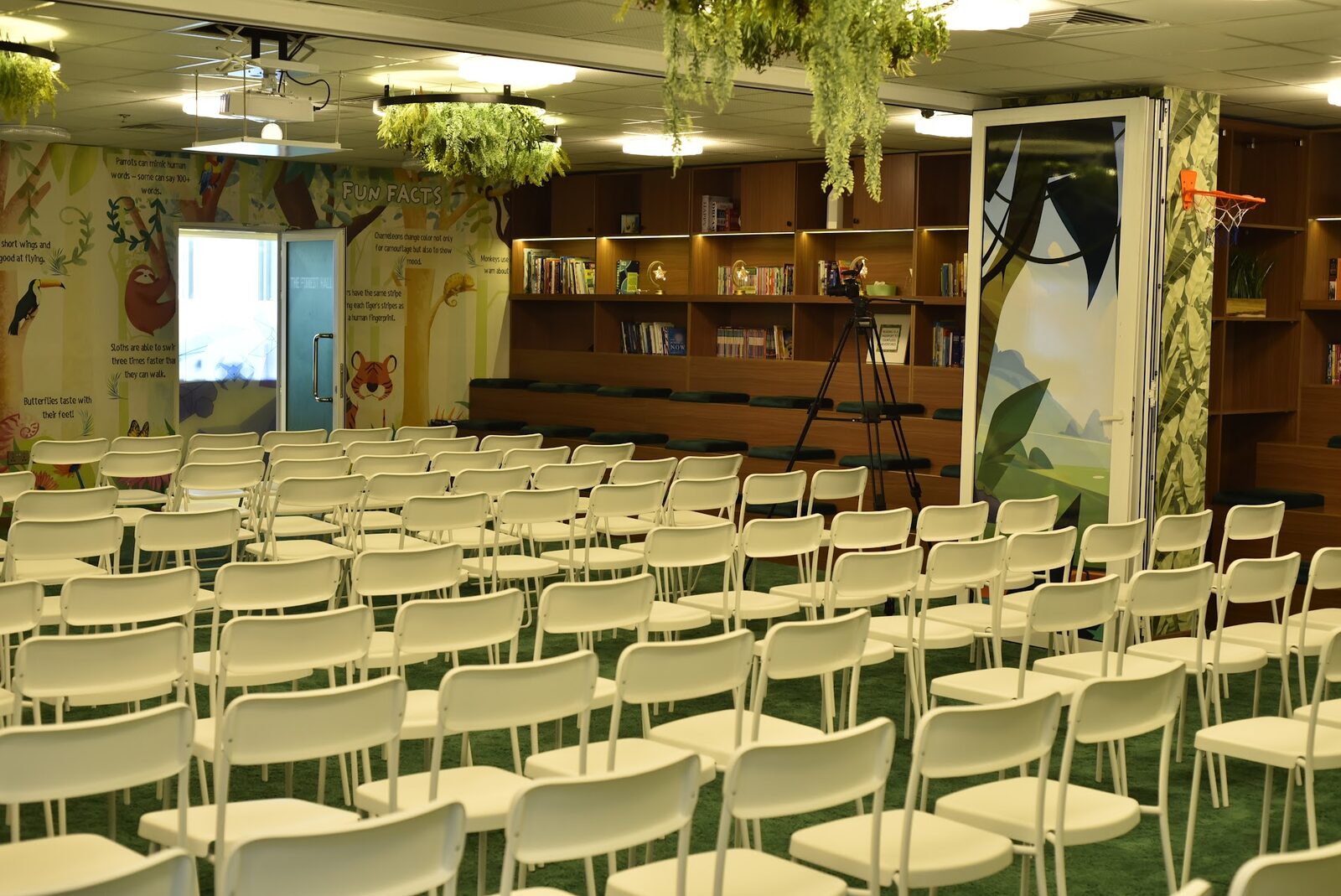 Forest Hall reading corner with bookshelves and jungle wall art