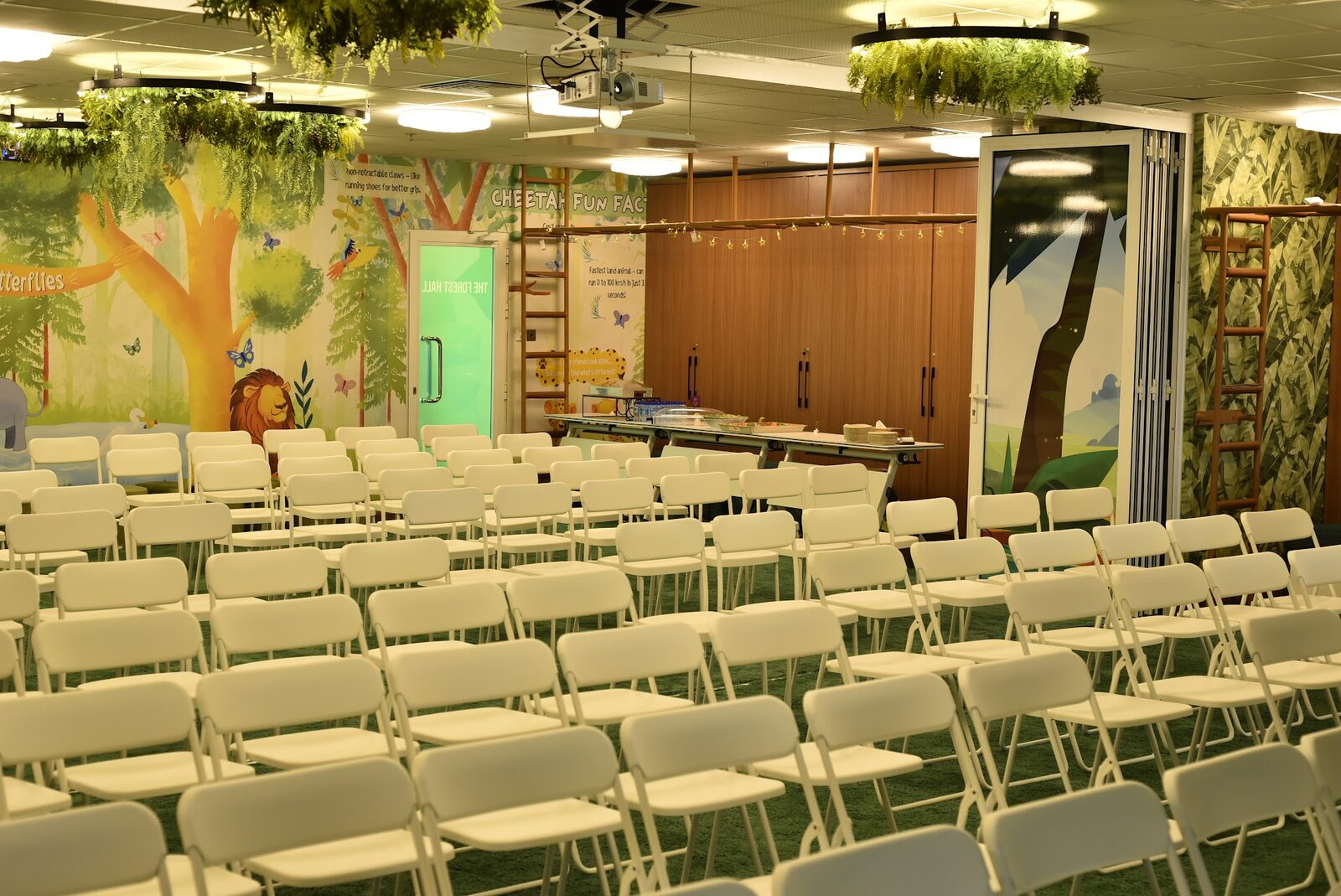 Forest Hall decorated with moon and star lights and a snacks table for an event