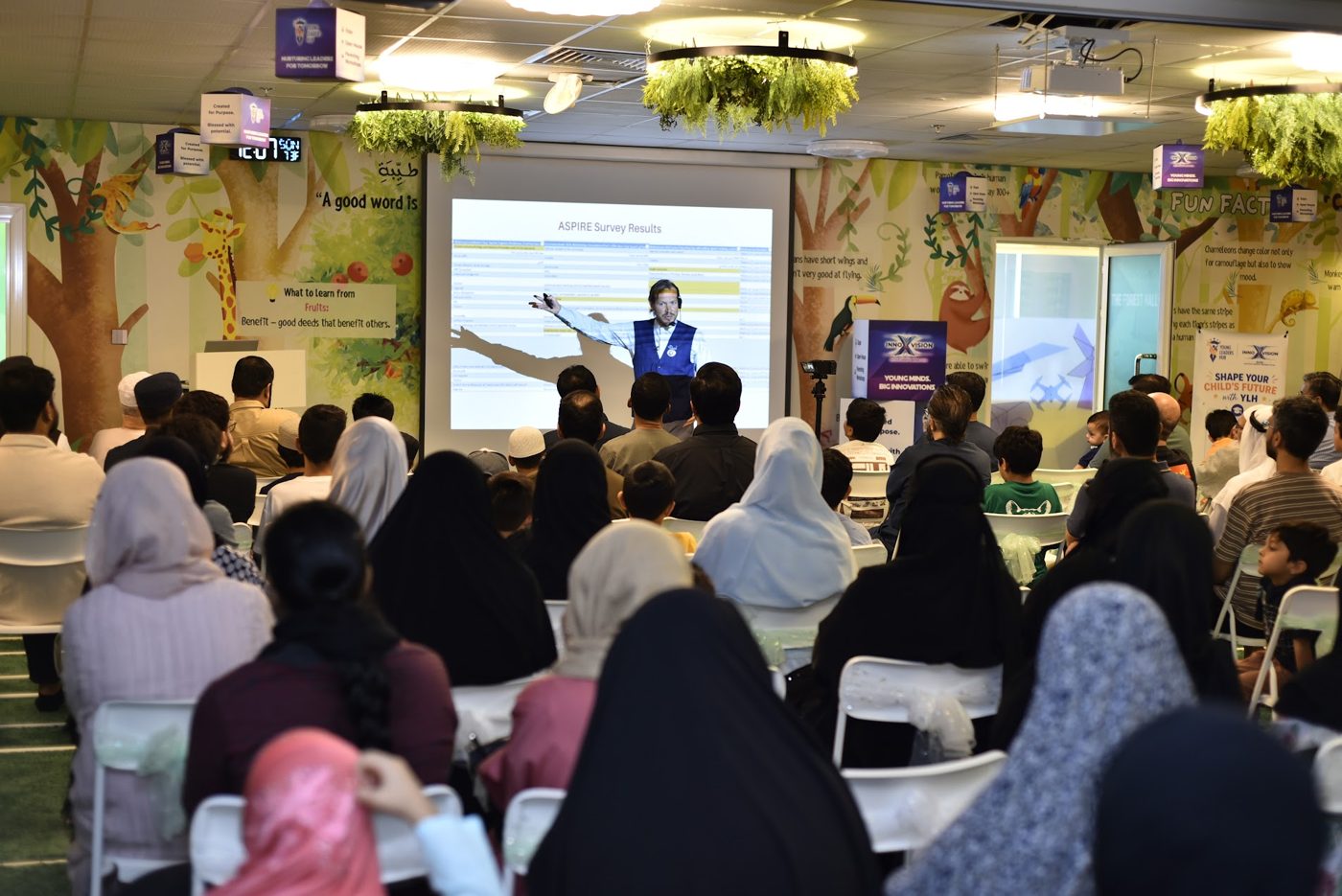 Families attending a presentation in the hall