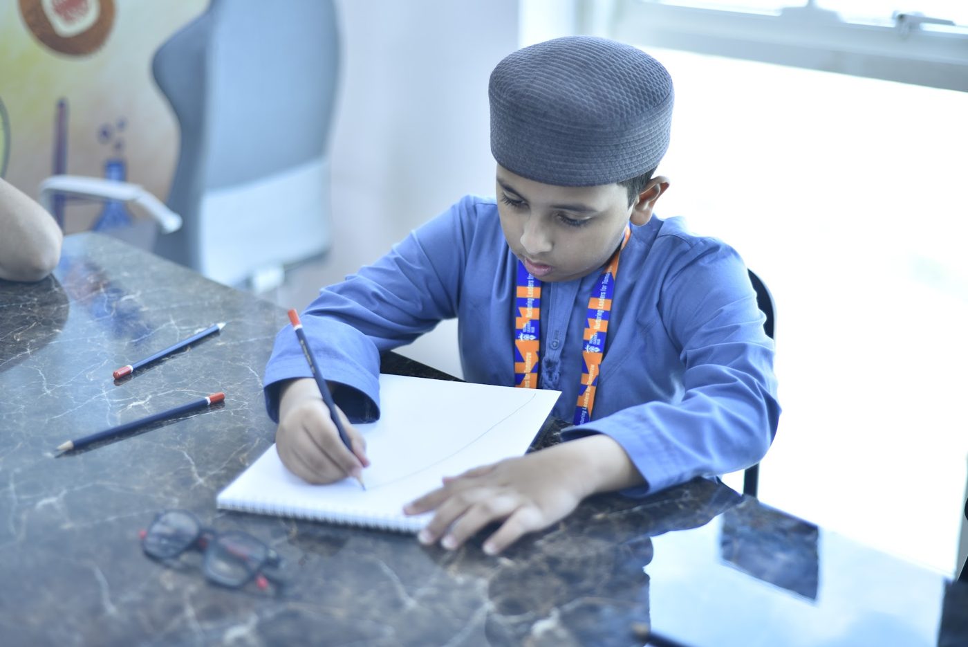 Student sketching with pencils in a drawing session