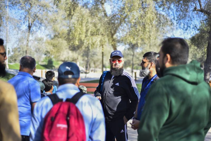 Group leader giving instructions to fathers and sons before setting off