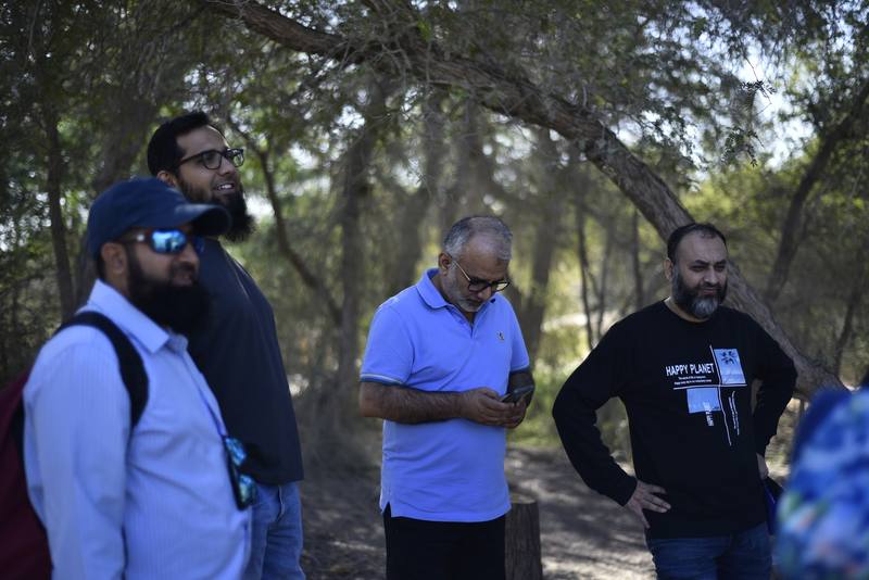 Fathers standing together in the shade before heading out