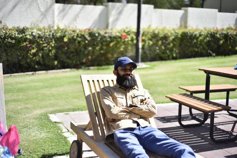 Father taking it easy on a lounger beside the lawn