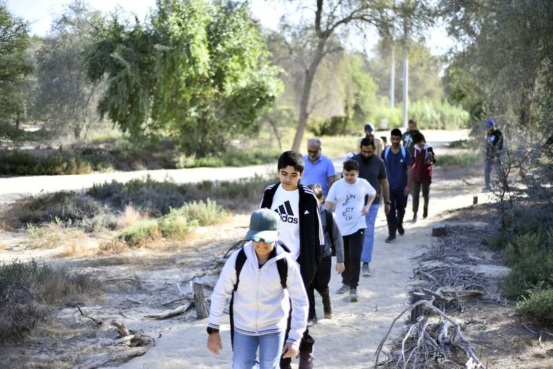 Boys leading the group along the sandy path