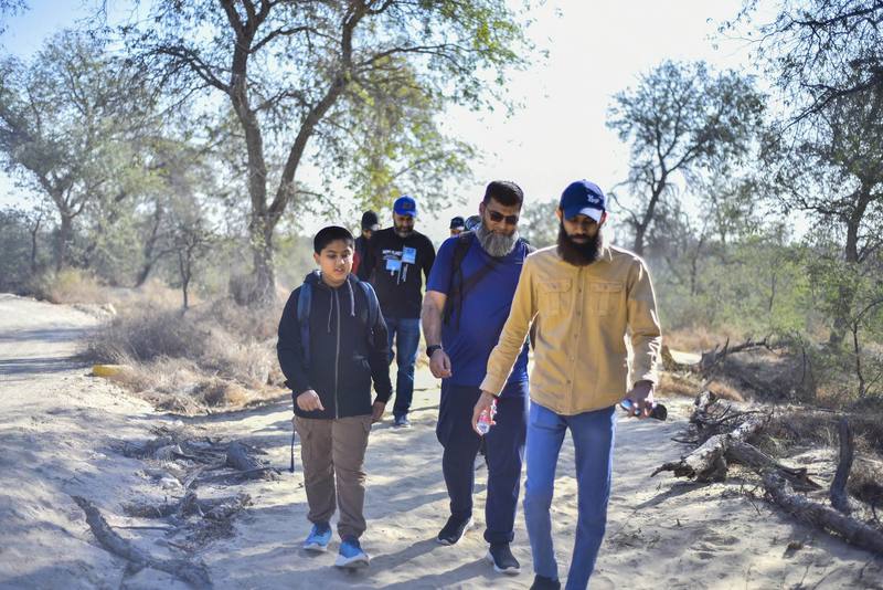 Fathers and sons walking side by side on the trail