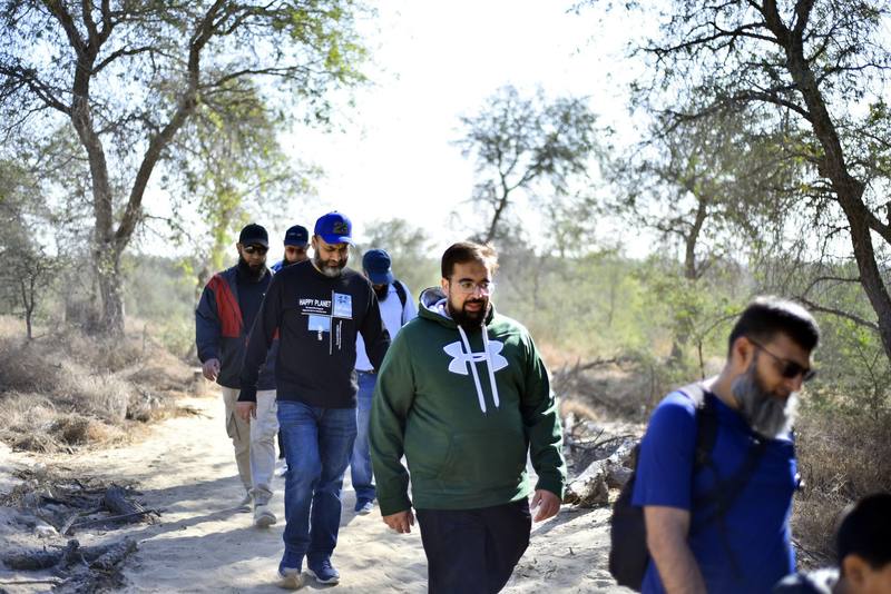 Group of fathers making their way along the desert track