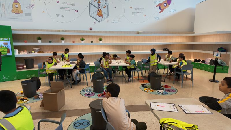 Students in hi-vis vests at a recycling workshop