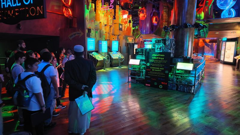Teacher and students at the Hall of Consumption exhibit