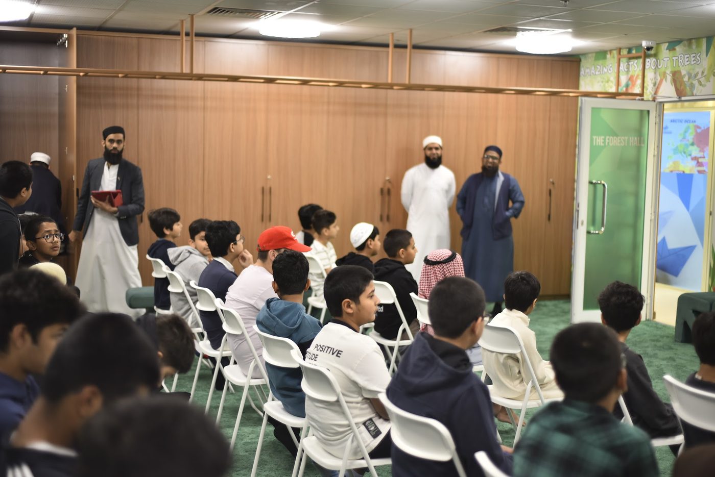 Students seated and listening attentively in the Forest Hall