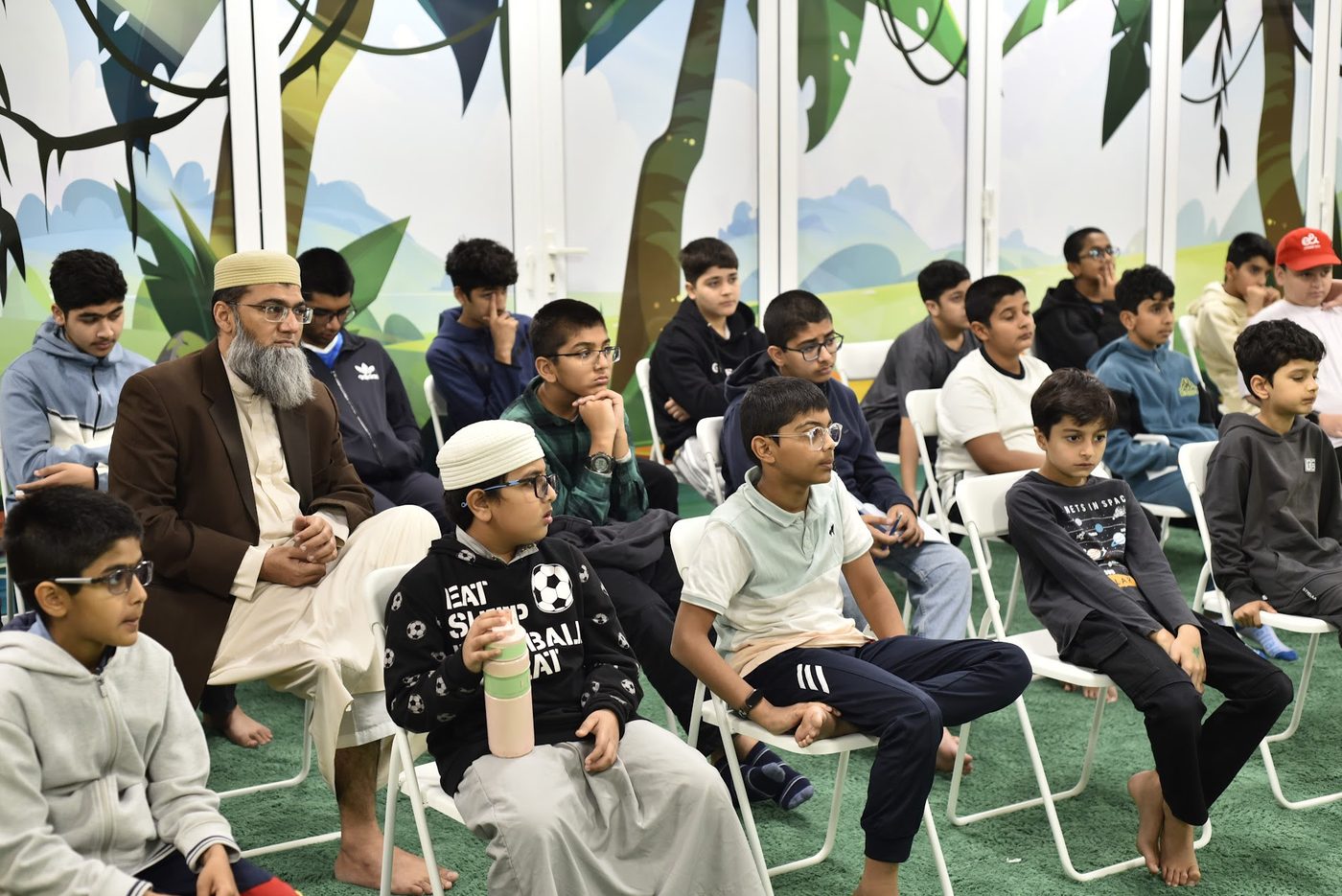Students and a mentor seated together listening to the talk