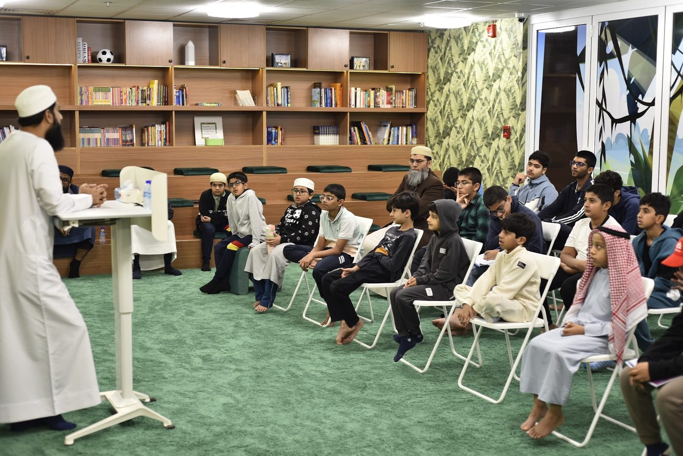 Students and a mentor seated in the library during the session