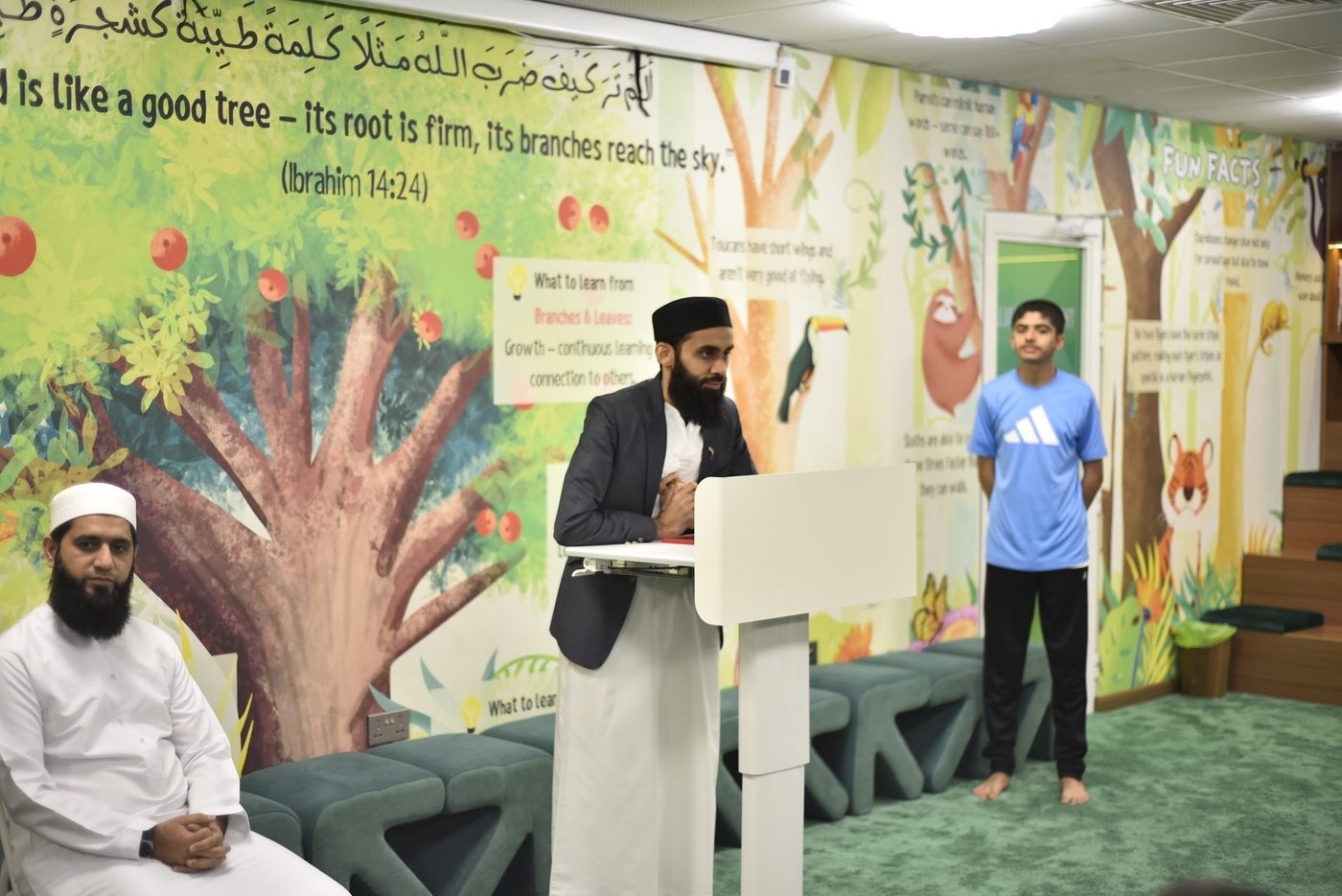 Abdullah Taimoor addressing students from the podium in the Forest Hall
