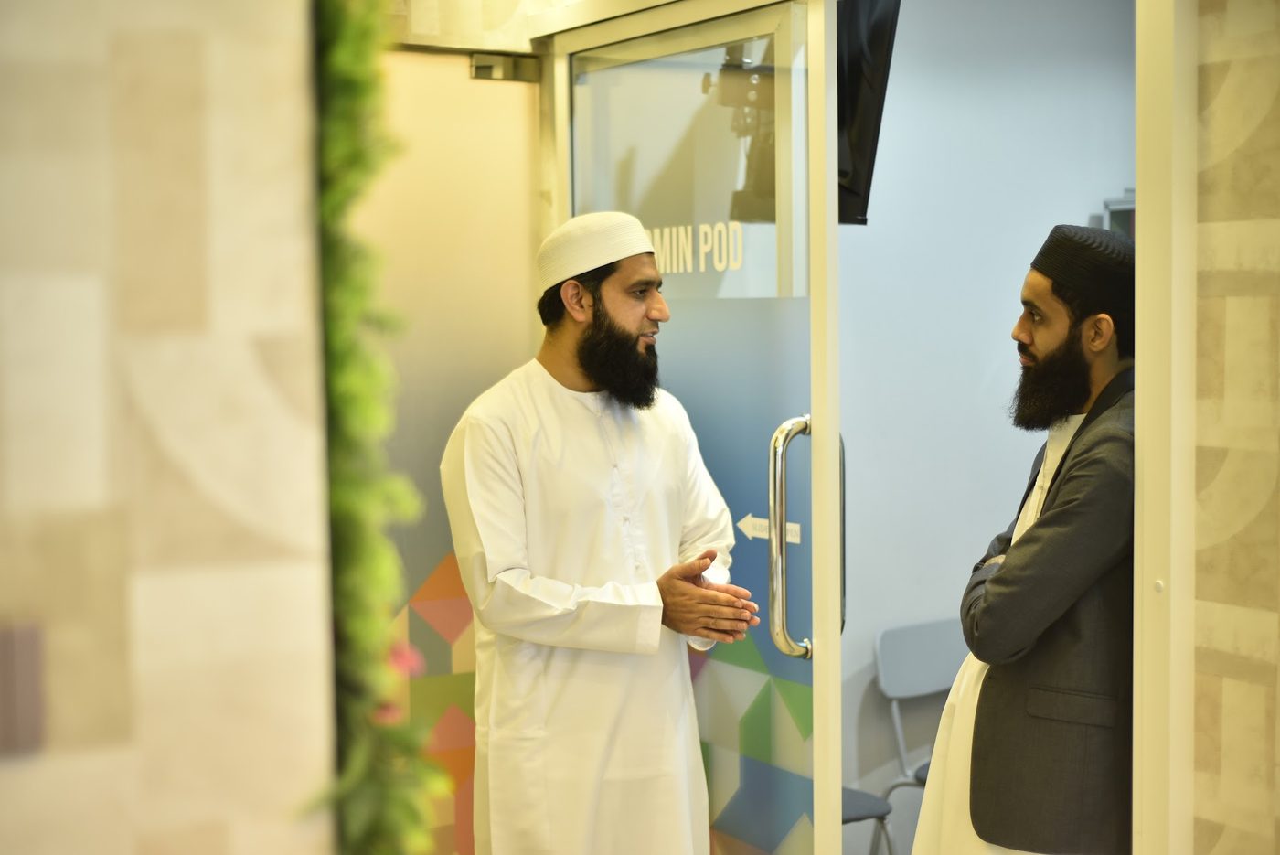 A conversation between two attendees near the Admin Pod