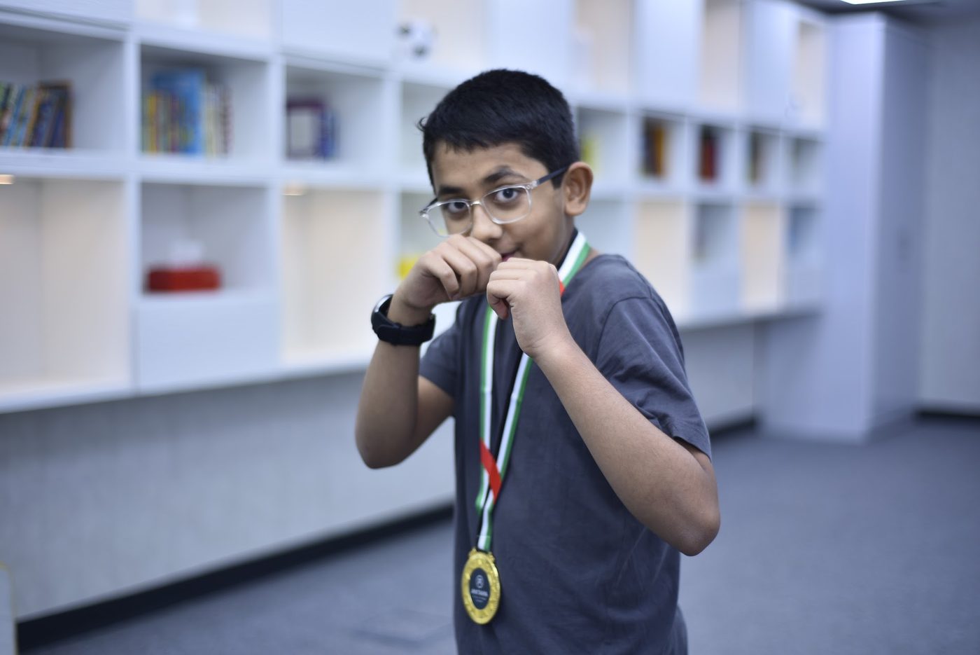 Competitor in a fighting stance wearing his gold medal