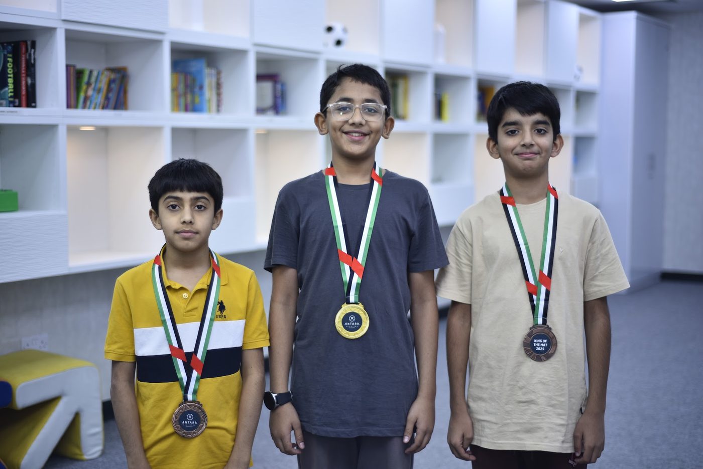 Three Jiu Jitsu medalists standing together wearing their medals