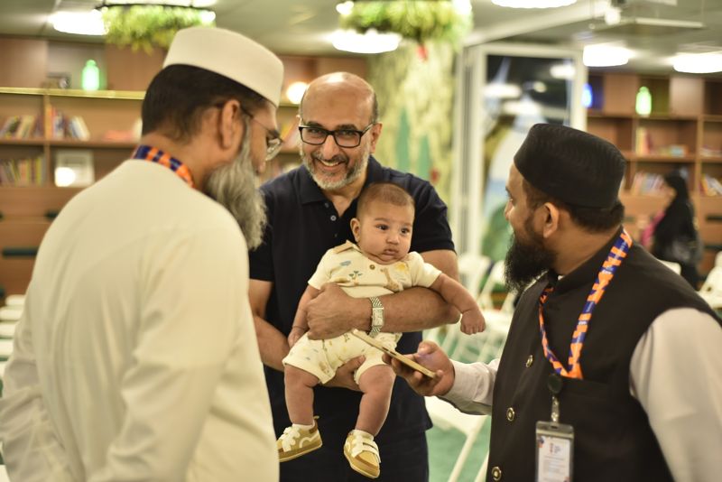 Fathers smiling with a baby at the event