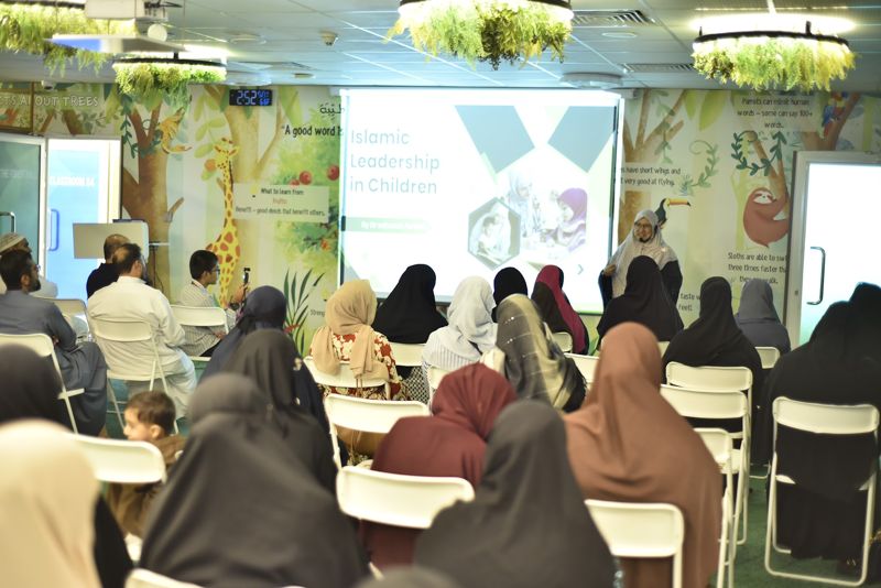 Mothers and fathers seated for the parenting session