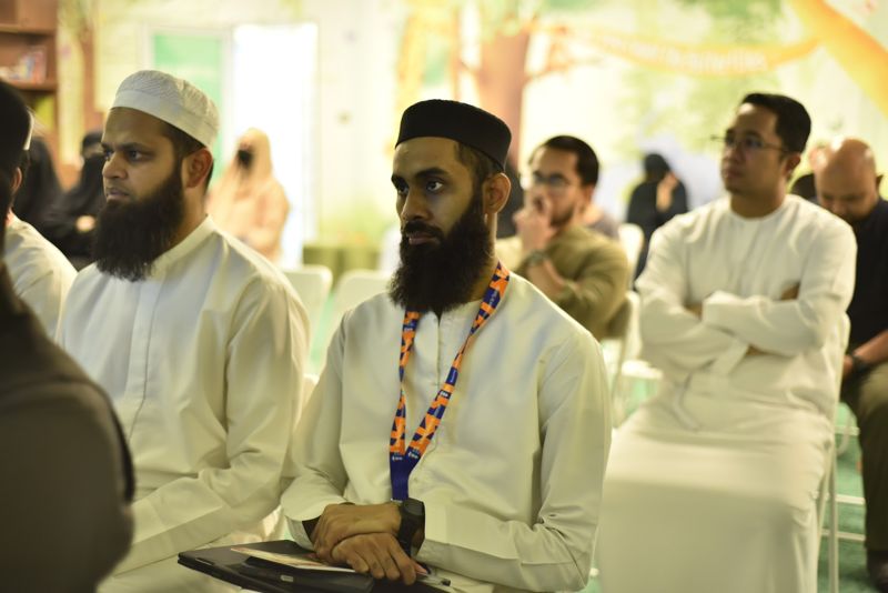 Fathers in the audience listening to the speaker