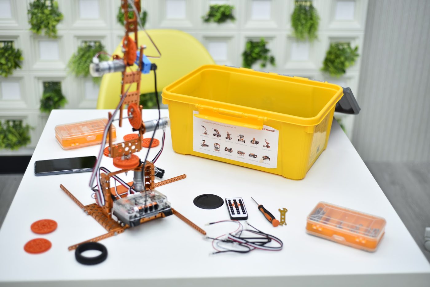 Robot arm built from a STEAM robotics kit with motors, wires and tools
