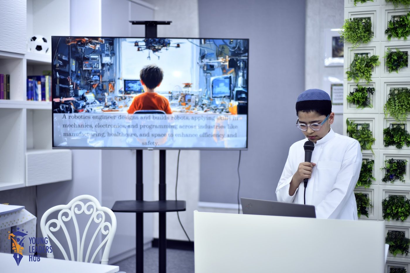 Student presenting his research to an audience with slides on screen